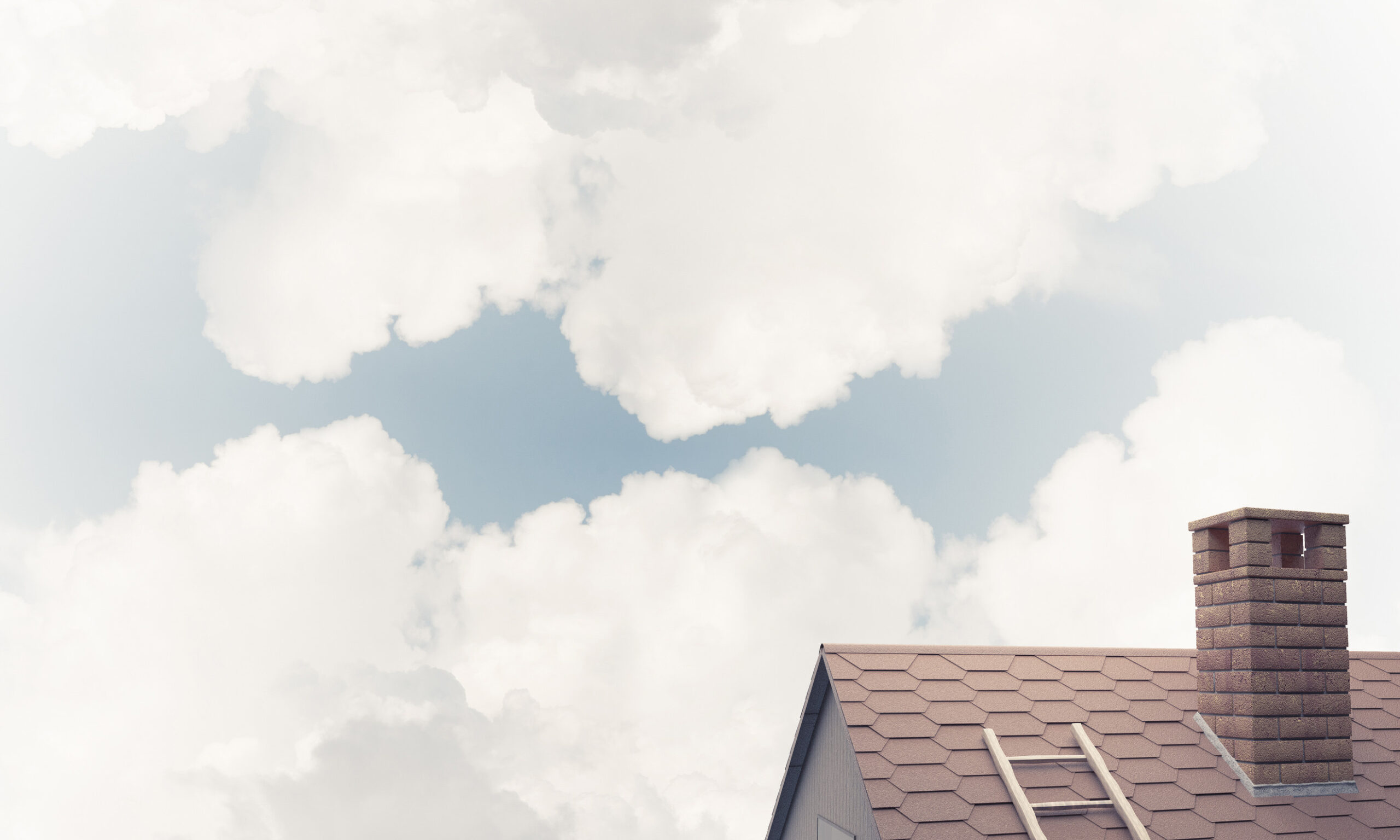 A rooftop with brown shingles and a brick chimney is visible in the lower right corner, set against a bright sky filled with large, fluffy white clouds.